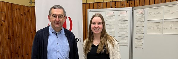 Norbert Krüger und Julia Sell aus dem Fachdienst Personal der Stadt Schleswig hinter einem Messestand der Stadt in der Dannewerkschule
